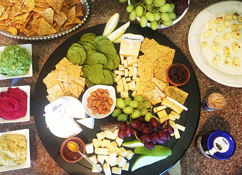 Appetizers, appetizer platter, cheese platter, cheese, brie, parmigiana, cheddar, beet hummus, avocado hummus, basil hummus, crackers, grapes, fruit, party, party platter, cheese tasting